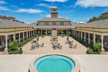 A large building with a pool in front.